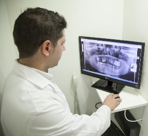 California radiology tech examining x ray on screen